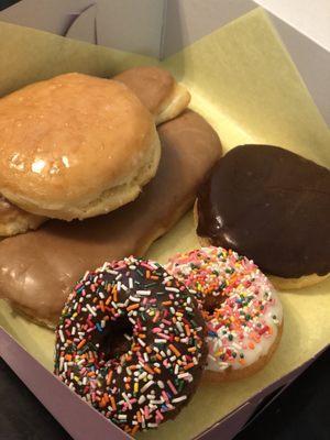 Half a dozen mixed variety of donuts (vanilla/chocolate sprinkles, glazed filled pastries and coffee flavored glazed donuts)