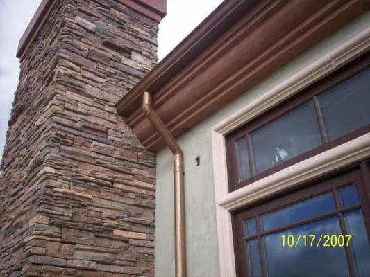 Copper 5" seamless gutter with 3" round down spout will add to the equity of your home while protecting from stucco staining.