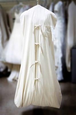 Wedding gown is covered with cotton preservation bag with Museum Method gown preservation