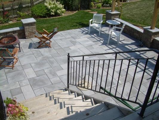 This patterned natural stone patio gives an elegant look yet provides a very functional gathering space.