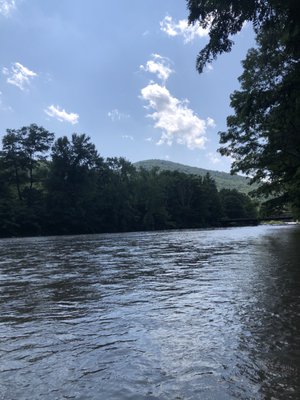 Beautiful view on the sky and mountains while enjoying the cool water in the creek