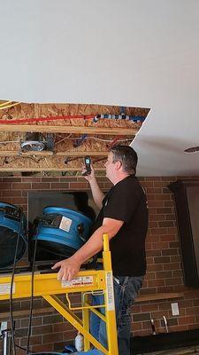 One of our technician's checking the moisture in the wood to make sure it is drying properly