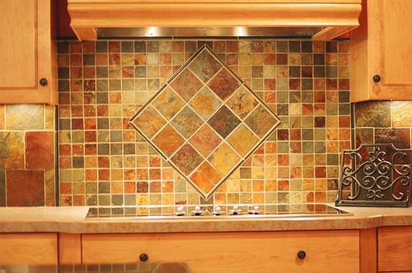 Tile backsplash featured behind a built-in stove