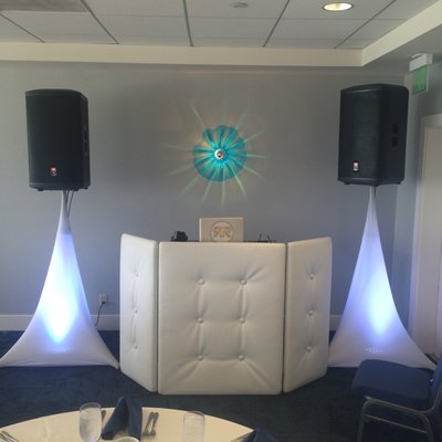 Leather DJ Booth with Glowing Speaker stands.