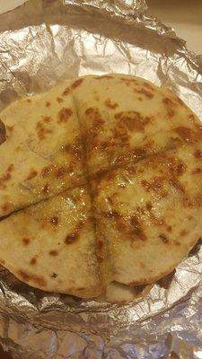 Oil drenched center of steak and cheese quesadilla