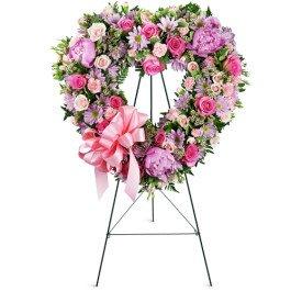 Heartfelt Condolences expressed with a heart custom designed in flowers of your choice to pay tribute to your loved one.