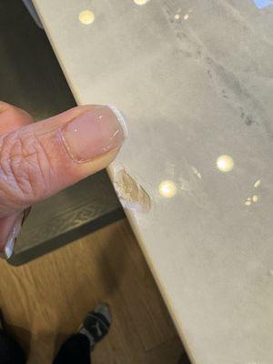 Porcelain countertop chipped from edge of pot hitting countertop.