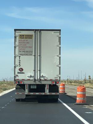 Back of truck that threw entire bag of garbage on road (in a construction zone no less where people are working.)