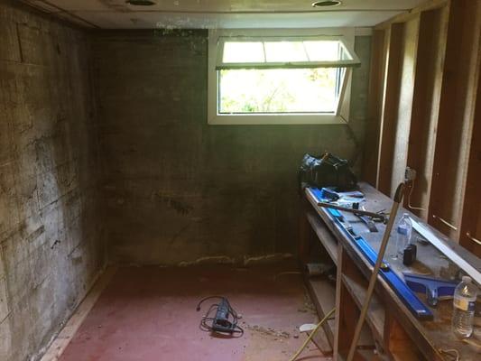 A dark closet in a basement gets a make over into a home office