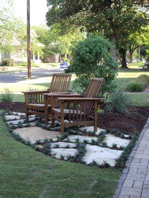 A flagstone sitting area with added dwarf mondo grass.