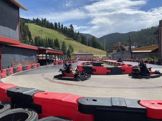 Kids on go carts beautiful mountain backdrop