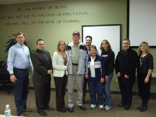 Sudden cardiac arrest survivor Gene Enright is flanked by his rescuers from Murietta Health Club, family, & Rescue Training Institute staff.