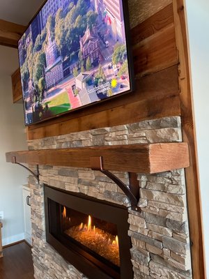 Mantel installation into existing stone fireplace.