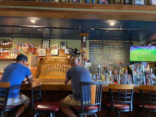 View of the bar and menu at All Sevens Brewing