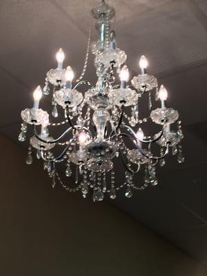 Pretty chandeliers hang in the hallway of the salon