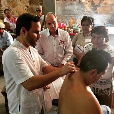 Dr. Chapa volunteers with various organizations offering Acupuncture in Mexico. Here, he is teaching his students how to treat patients