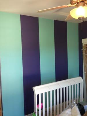 Colorful vertical stripes liven up a girls bedroom.