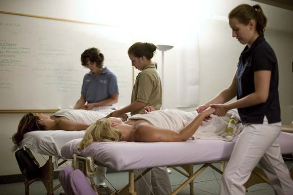 Instructor (left) working with students in Regional Masage