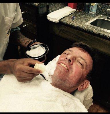 A relax client prepare for a shave