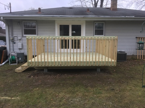 Removed existing window and replaced with a patio door. Constructed wood deck.