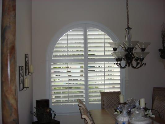 Plantation shutters on a palladium window. Shutters can cover all those hard to treat angled, curved, round etc.