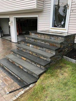 Veneer stone steps with blue stone treads.