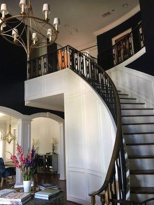 We added the wall and arched opening moldings and painted the high contrast trim white against the dark navy walls for added drama