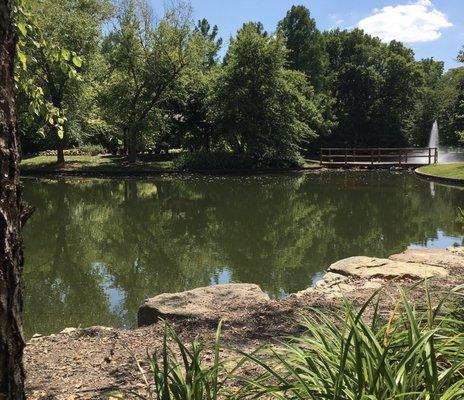 Lake view of fountain and bridge to shaded gazebo.