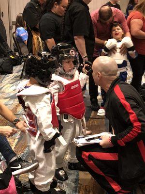 Mr. Garcia coaching a 3 year old in sparring at a tournament which he won 1st place.