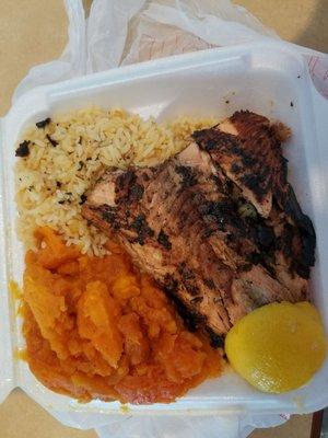 Grilled salmon with jerk sauce, candied yams and yellow rice