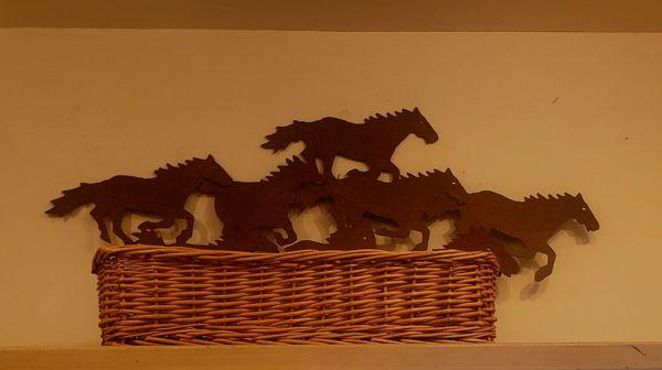 If you look up high you will see this sculpture of wild horses running...