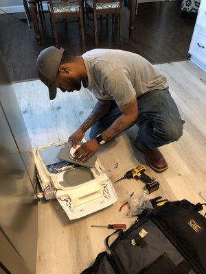 Isaiah working on a Samsung Refrigerator