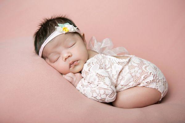 Sleeping baby girl during newborn session.