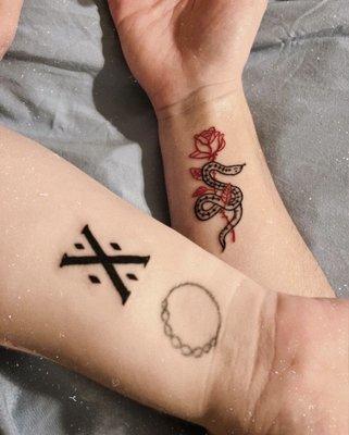 Mine is the all black symbol (disregard the prior stick-n-poke below) and my friend got the rose & snake. Great fine line work!