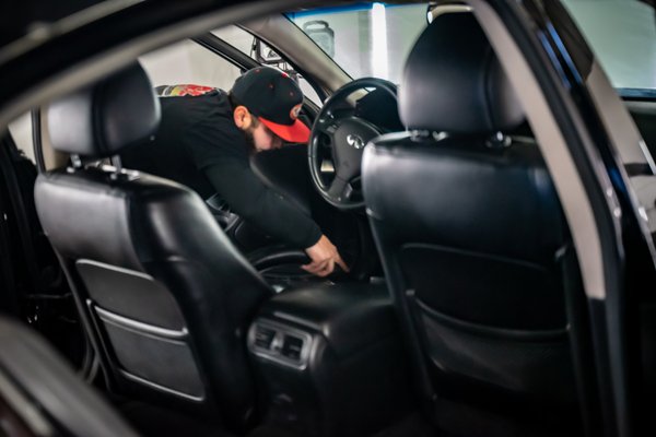 Our shop manager William doing some final touch ups to this Infiniti before pickup