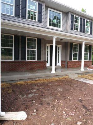 New concrete added to front door of house, photo taken after completion