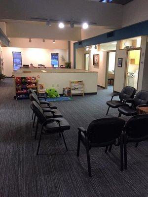 Waiting room on upper floor of RKL. Reception desk as you walk in, comfortable seating and kids activity center.