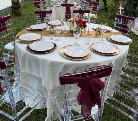 Clear Chiavari Chairs with Burgundy Chair sashes Thanksgiving Dinner Guest Table Setup