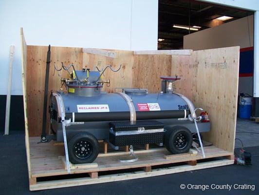 Securing a rolling tank in a custom fully enclosed wooden box.