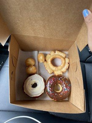 Donut holes, Red Velvet with Cream Cheese Donut, Sour Cream Donut, and Chocolate Sprinkled Donut! So good and such good costumer service!