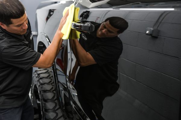 One of Prestige Auto Appearance Staff members removing Ceramic Coating from a Truck's Paint. After Paint Correction and  Polishing was done.