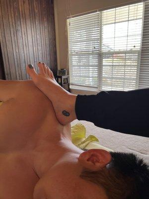 Releasing upper trapezius in a barefoot Ashiatsu massage.