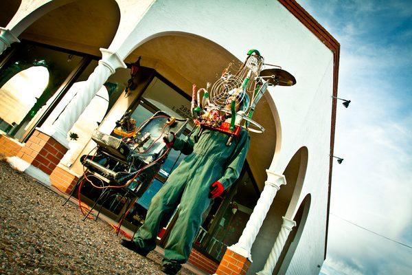 Scientist-artist Ned Schaper wearing "The Painful Moment Simulator" sculpture outside Mat Bevel's Museum Of Kinetic Art