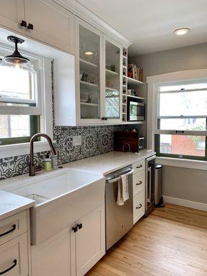 Our finished kitchen after Helton Enterprises installed countertops, a farmhouse sink, new can lights, appliances, and applied fresh paint.