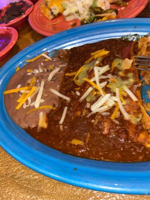 Cheese n onion enchilada with Refried beans came with rice I've already ate the rice good food