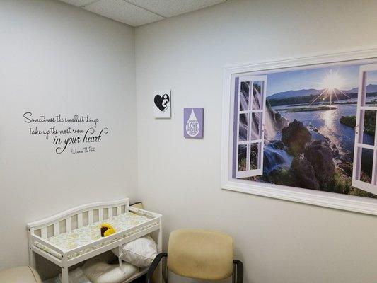 Changing table on the nursing nook and extra chair used by lactation consultant