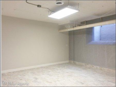 Studio A with a tile floor and big window well.  Also has dual slop sink and floor drain.