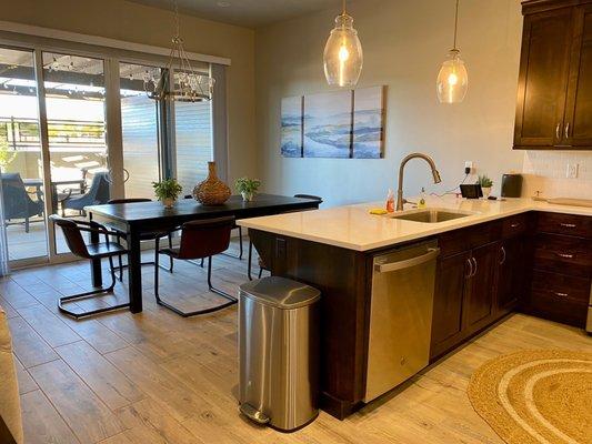 Kitchen are, left side is living room, patio shown through glass doors.