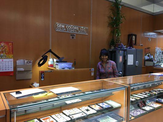 Store Front of Gem Colors, with owner, Anju posing for the camera