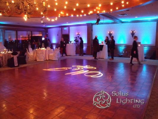 String lights over the dance floor, custom monogram projected onto the dance floor, uplights & highlighted centerpieces.